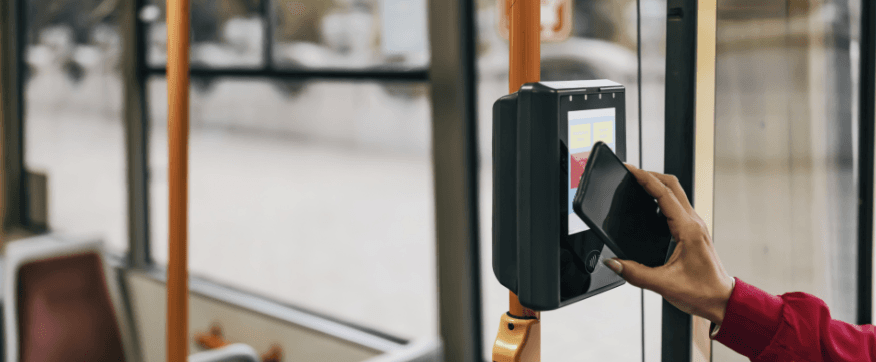 Passenger tapping a phone on a bus validator